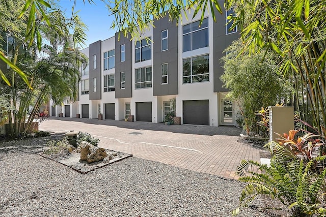 325 5th Ave S Unit 9, Saint Petersburg, FL 33701 - view of building exterior featuring an attached garage and driveway