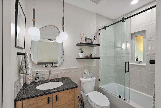 325 5th Ave S Unit 9, Saint Petersburg, FL 33701 - full bath featuring vanity, bath / shower combo with glass door, and a wainscoted wall