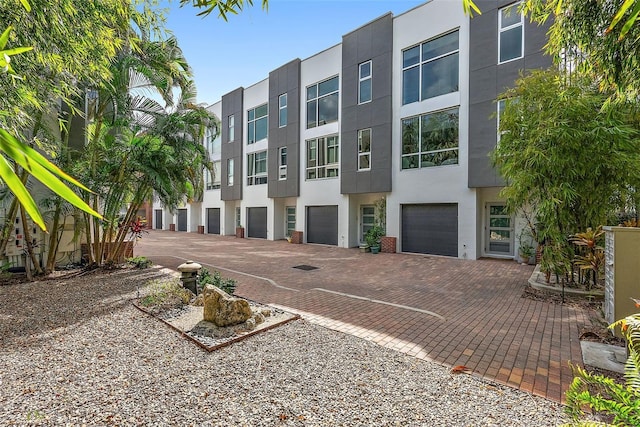 325 5th Ave S Unit 9, Saint Petersburg, FL 33701 - view of building exterior featuring an attached garage and driveway