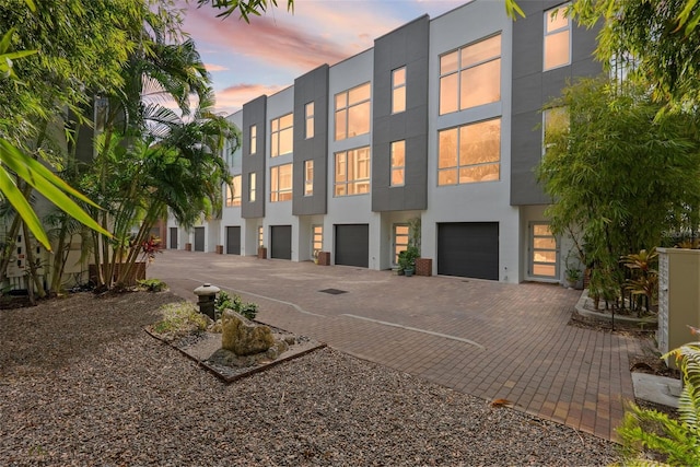 325 5th Ave S Unit 9, Saint Petersburg, FL 33701 - property at dusk with driveway and a garage