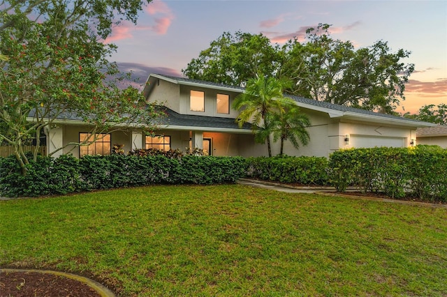 2272 Adam Ct, Palm Harbor, FL 34683 - view of front of home featuring stucco siding, a lawn, and a garage