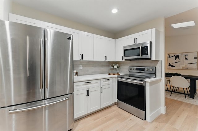 2272 Adam Ct, Palm Harbor, FL 34683 - kitchen featuring stainless steel appliances, light countertops, light wood-type flooring, decorative backsplash, and recessed lighting