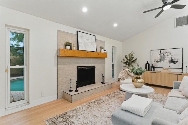 2272 Adam Ct, Palm Harbor, FL 34683 - living area featuring lofted ceiling, light wood-type flooring, ceiling fan, a fireplace, and recessed lighting