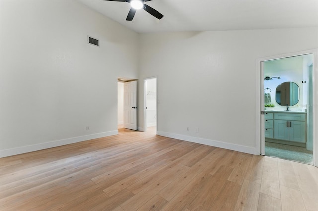 2272 Adam Ct, Palm Harbor, FL 34683 - empty room featuring ceiling fan, light wood-style flooring, and high vaulted ceiling