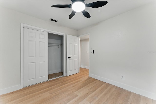 2272 Adam Ct, Palm Harbor, FL 34683 - unfurnished bedroom with light wood-type flooring, a closet, and a ceiling fan