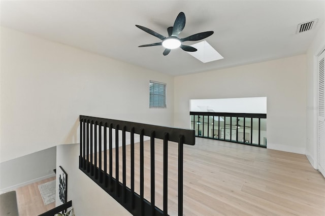 2272 Adam Ct, Palm Harbor, FL 34683 - staircase with a ceiling fan, wood finished floors, and a skylight