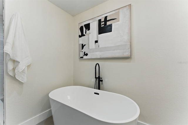 2272 Adam Ct, Palm Harbor, FL 34683 - bathroom with baseboards and a freestanding bath