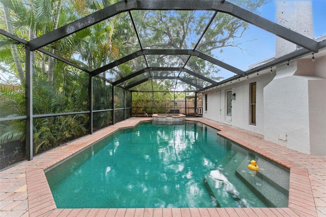 2272 Adam Ct, Palm Harbor, FL 34683 - view of pool featuring a pool with connected hot tub, a patio area, and glass enclosure