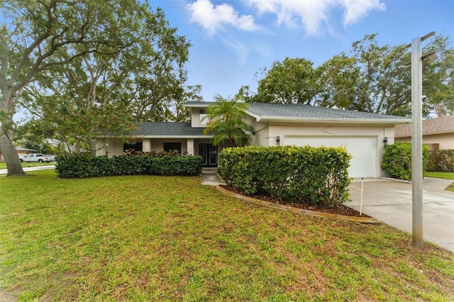2272 Adam Ct, Palm Harbor, FL 34683 - view of front of home featuring an attached garage, driveway, a front lawn, and stucco siding