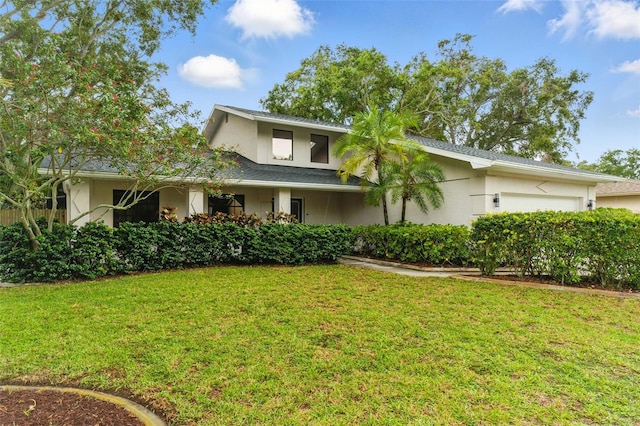 2272 Adam Ct, Palm Harbor, FL 34683 - view of front of house featuring stucco siding, a front lawn, and an attached garage