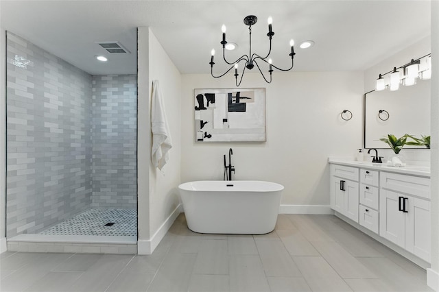 2272 Adam Ct, Palm Harbor, FL 34683 - full bathroom featuring double vanity, a soaking tub, a tile shower, tile patterned floors, and a chandelier