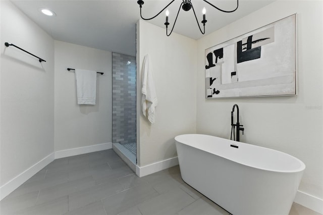2272 Adam Ct, Palm Harbor, FL 34683 - full bathroom with a freestanding bath, tiled shower, a chandelier, tile patterned floors, and recessed lighting