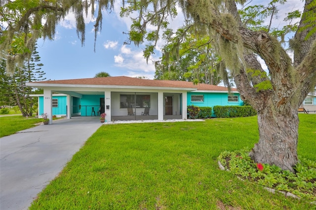 301 Carlyle Blvd, Ruskin, FL 33570 - view of front facade featuring a front yard, an attached carport, and driveway