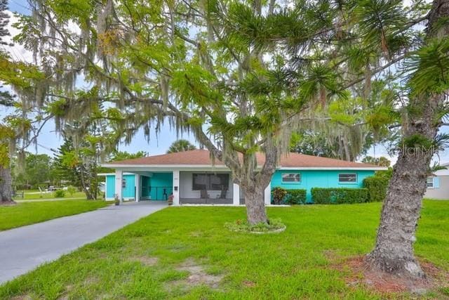 301 Carlyle Blvd, Ruskin, FL 33570 - single story home with a front yard, driveway, and a carport