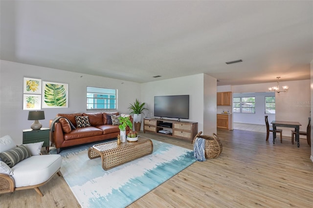 301 Carlyle Blvd, Ruskin, FL 33570 - living area featuring a chandelier and light wood-style floors