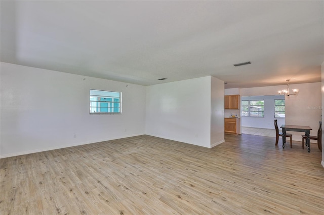 301 Carlyle Blvd, Ruskin, FL 33570 - unfurnished room with a chandelier and light wood-type flooring