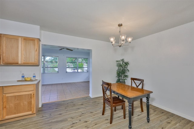 301 Carlyle Blvd, Ruskin, FL 33570 - dining area with a chandelier, light wood-type flooring, and a ceiling fan