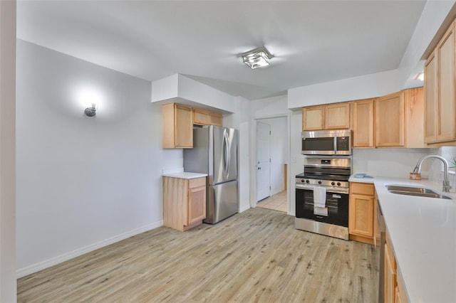 301 Carlyle Blvd, Ruskin, FL 33570 - kitchen featuring appliances with stainless steel finishes, light wood finished floors, light countertops, and light brown cabinetry