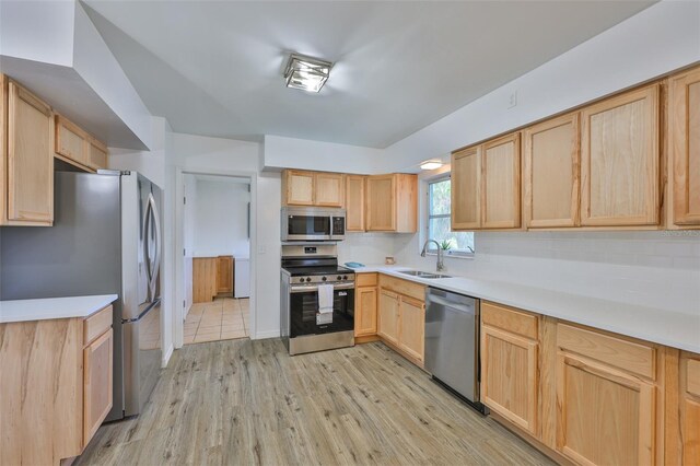 301 Carlyle Blvd, Ruskin, FL 33570 - kitchen featuring stainless steel appliances, light brown cabinetry, light wood-style floors, and light countertops