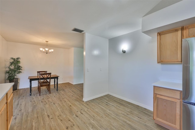 301 Carlyle Blvd, Ruskin, FL 33570 - dining space featuring light wood-type flooring and a chandelier
