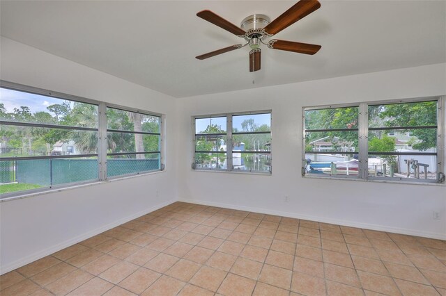 301 Carlyle Blvd, Ruskin, FL 33570 - spare room with ceiling fan, plenty of natural light, and light tile patterned flooring