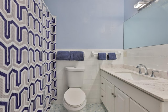 301 Carlyle Blvd, Ruskin, FL 33570 - full bathroom with vanity, tile walls, wainscoting, a shower with shower curtain, and tile patterned flooring