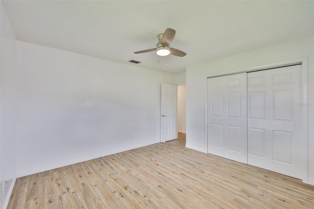 301 Carlyle Blvd, Ruskin, FL 33570 - unfurnished bedroom featuring wood finished floors, a closet, and a ceiling fan