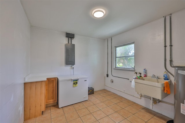 301 Carlyle Blvd, Ruskin, FL 33570 - laundry area with cabinet space, electric panel, water heater, and light tile patterned flooring