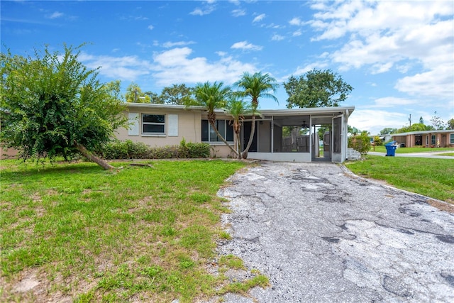 11896 104th Ln, Largo, FL 33773 - view of front of property featuring a sunroom and a front lawn