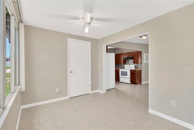 11896 104th Ln, Largo, FL 33773 - unfurnished living room featuring a ceiling fan and light tile patterned flooring