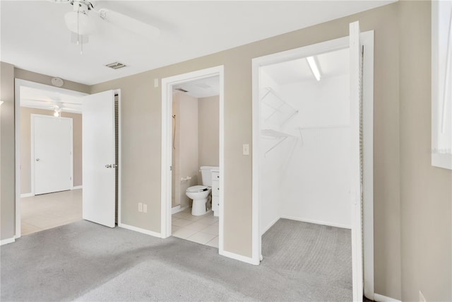 11896 104th Ln, Largo, FL 33773 - unfurnished bedroom with carpet, a spacious closet, connected bathroom, a closet, and ceiling fan