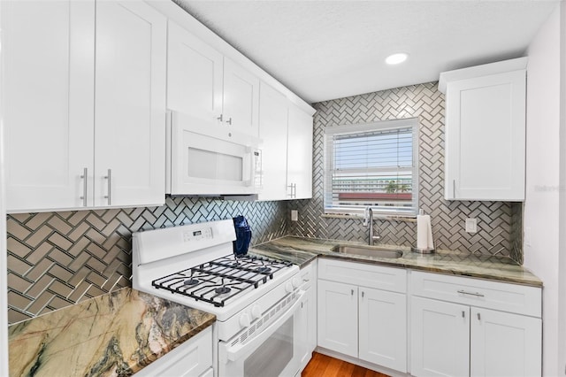 3018 59th St S Unit 405, Gulfport, FL 33707 - kitchen featuring white appliances, tasteful backsplash, stone countertops, and recessed lighting