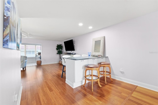 3018 59th St S Unit 405, Gulfport, FL 33707 - kitchen with a kitchen breakfast bar, light wood-style floors, recessed lighting, and a peninsula