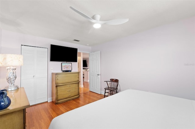 3018 59th St S Unit 405, Gulfport, FL 33707 - bedroom with light wood-style floors, a closet, and ceiling fan