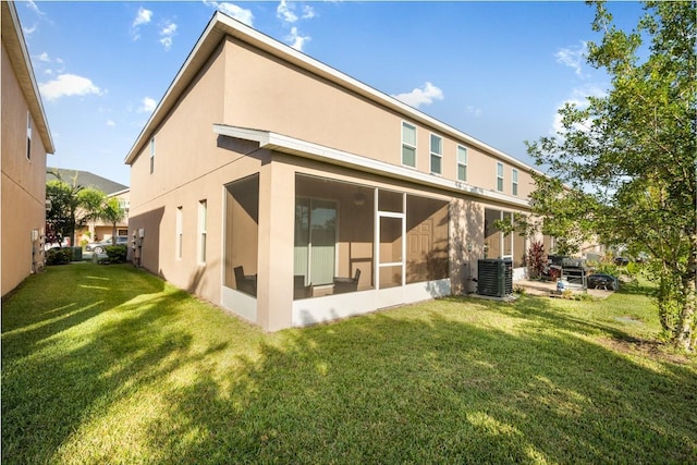 1218 Grantham Dr, Sarasota, FL 34234 - back of house with stucco siding, a lawn, and a sunroom