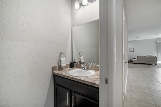1218 Grantham Dr, Sarasota, FL 34234 - bathroom with vanity, a textured wall, and tile patterned flooring