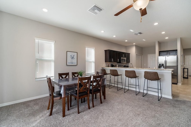 1218 Grantham Dr, Sarasota, FL 34234 - dining area featuring light colored carpet, a ceiling fan, and recessed lighting