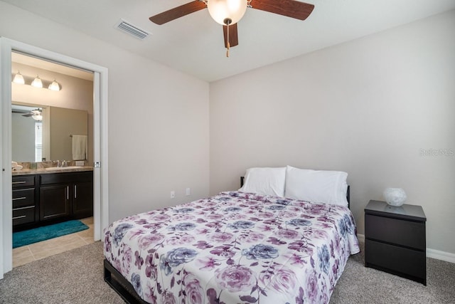 1218 Grantham Dr, Sarasota, FL 34234 - bedroom with light colored carpet, ensuite bathroom, and a ceiling fan