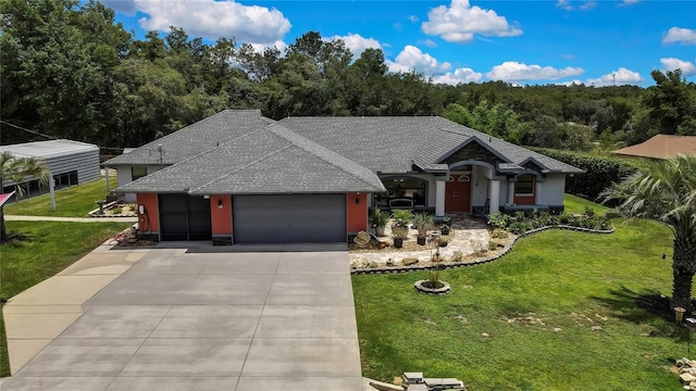 10721 N Ocean Dr, Dunnellon, FL 34434 - view of front facade featuring a garage, a shingled roof, concrete driveway, a front lawn, and stucco siding