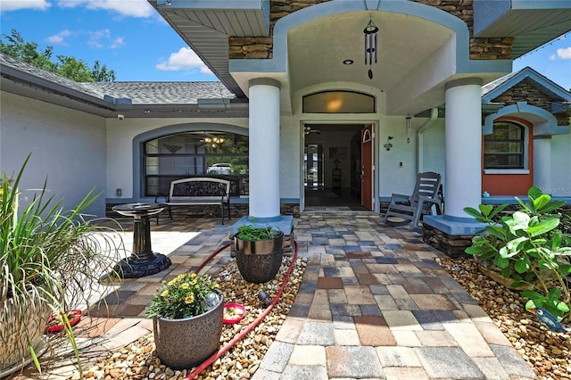 10721 N Ocean Dr, Dunnellon, FL 34434 - view of exterior entry featuring stucco siding and a shingled roof