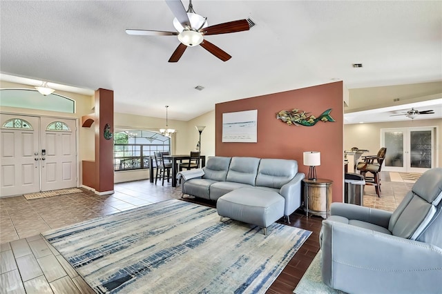 10721 N Ocean Dr, Dunnellon, FL 34434 - living room with a ceiling fan, lofted ceiling, a chandelier, wood tiled floors, and arched walkways