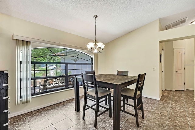 10721 N Ocean Dr, Dunnellon, FL 34434 - tiled dining room featuring a textured ceiling and a chandelier