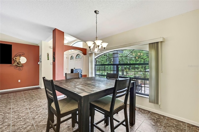 10721 N Ocean Dr, Dunnellon, FL 34434 - dining room featuring vaulted ceiling, a chandelier, and a textured ceiling
