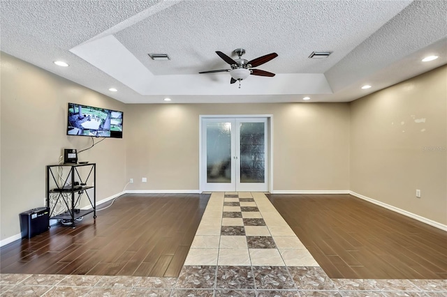 10721 N Ocean Dr, Dunnellon, FL 34434 - unfurnished room with wood finish floors, ceiling fan, a textured ceiling, french doors, and recessed lighting