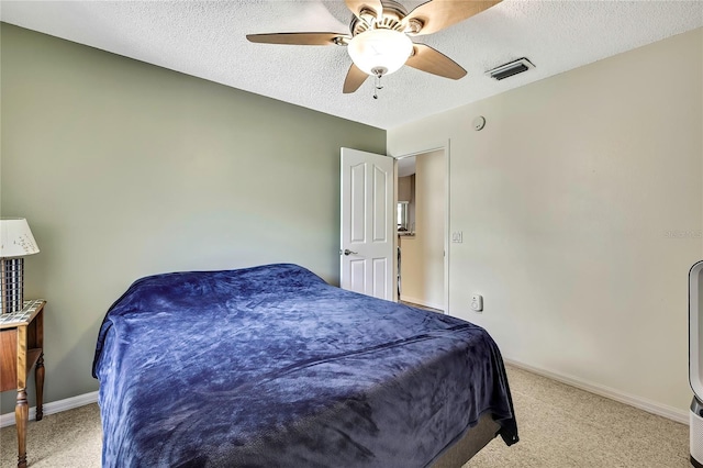 10721 N Ocean Dr, Dunnellon, FL 34434 - bedroom with light colored carpet, a ceiling fan, and a textured ceiling