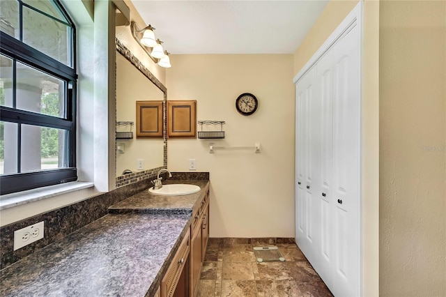 10721 N Ocean Dr, Dunnellon, FL 34434 - bathroom with a closet, stone finish floors, and vanity