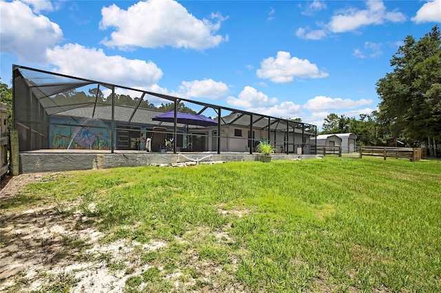 10721 N Ocean Dr, Dunnellon, FL 34434 - back of house with glass enclosure and a storage unit