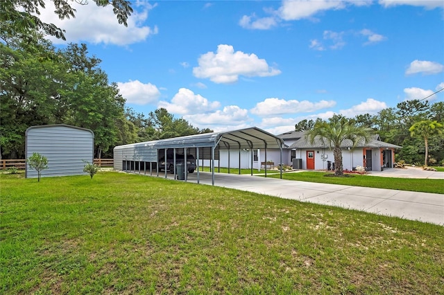 10721 N Ocean Dr, Dunnellon, FL 34434 - view of front of home with a detached carport, a front lawn, and driveway