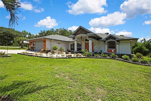 10721 N Ocean Dr, Dunnellon, FL 34434 - view of front of home with stucco siding, a garage, a front yard, and driveway