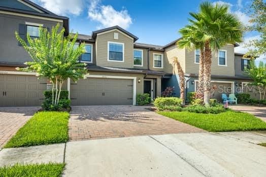 28504 Tranquil Lake Cir, Wesley Chapel, FL 33543 - view of front facade with decorative driveway and a garage